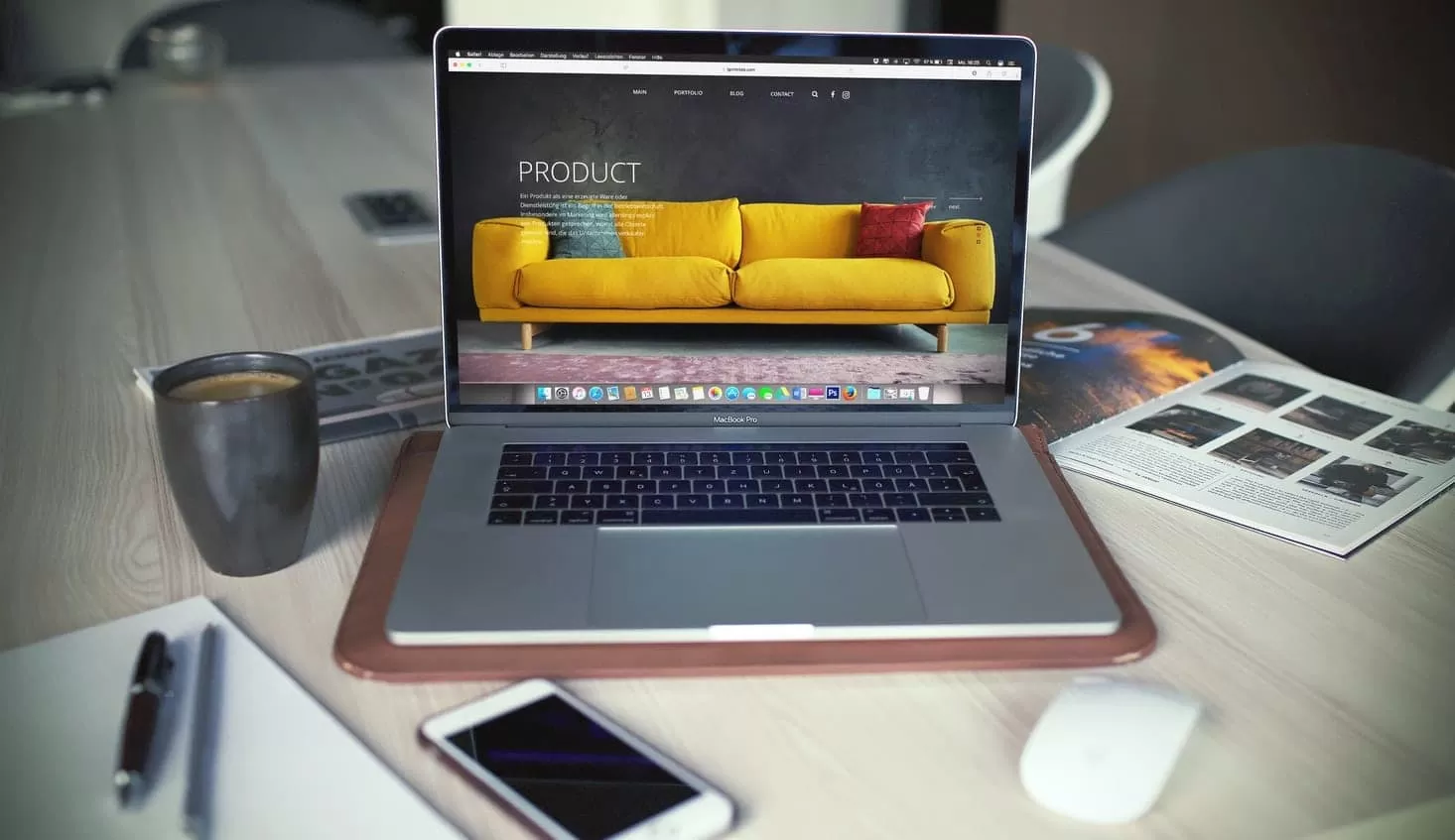 Apple Macbook and iPhone with website of sofa company